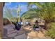 Charming backyard patio with comfortable seating, fire pit, lush landscaping and desert views at 26521 N 114Th Pl, Scottsdale, AZ 85255