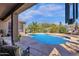 Inviting backyard pool and patio area with comfortable seating, perfect for relaxing and enjoying the desert landscape at 26521 N 114Th Pl, Scottsdale, AZ 85255