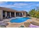 Backyard pool with desert landscaping, patio seating and lounge chairs, perfect for entertaining at 26521 N 114Th Pl, Scottsdale, AZ 85255