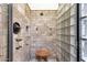 Modern walk-in shower with beautiful tile work and a comfortable wooden seat, creating a spa-like experience at 26521 N 114Th Pl, Scottsdale, AZ 85255