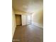 Small, carpeted bedroom featuring sliding closet doors and a barred window at 2666 N 43Rd Ave # C, Phoenix, AZ 85009