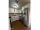 This kitchen features stainless steel appliances and updated white cabinets at 2666 N 43Rd Ave # C, Phoenix, AZ 85009