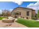 Expansive backyard boasts a built-in grill, fire pit, manicured grass, and desert landscaping at 27315 N 83Rd Dr, Peoria, AZ 85383