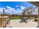Outdoor living space offering a built-in grill, bar seating and dining with beautiful landscaping at 27315 N 83Rd Dr, Peoria, AZ 85383