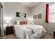 Cozy bedroom with soft lighting, comfortable bed with decorative pillows, and neutral decor for a relaxing ambiance at 27315 N 83Rd Dr, Peoria, AZ 85383