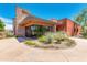 Community clubhouse with a stone exterior, desert landscaping and ample parking at 27315 N 83Rd Dr, Peoria, AZ 85383