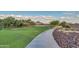 Beautiful desert community featuring a walking path, green spaces, and mountain views at 27315 N 83Rd Dr, Peoria, AZ 85383
