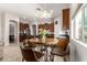 Bright dining area features a wooden table, leather chairs, and views of the modern kitchen appliances at 27315 N 83Rd Dr, Peoria, AZ 85383