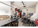 Spacious garage with workshop area, equipped with tools and ample storage solutions at 27315 N 83Rd Dr, Peoria, AZ 85383