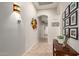 Long hallway with tile flooring, modern lighting, and decorative artwork on the walls at 27315 N 83Rd Dr, Peoria, AZ 85383