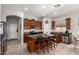 Kitchen with dark wood cabinets, stainless steel appliances, and a large island with seating at 27315 N 83Rd Dr, Peoria, AZ 85383