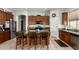 Kitchen with dark wood cabinets, stainless steel appliances, and a central island at 27315 N 83Rd Dr, Peoria, AZ 85383