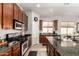 Kitchen with dark wood cabinets, granite countertops, and stainless steel appliances at 27315 N 83Rd Dr, Peoria, AZ 85383