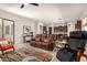 Open-concept living space with a leather sofa, tiled floors, and access to the kitchen at 27315 N 83Rd Dr, Peoria, AZ 85383