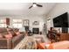 Spacious living room featuring a fireplace, comfortable seating, and abundant natural light at 27315 N 83Rd Dr, Peoria, AZ 85383