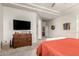 Main bedroom featuring a dresser, neutral colors, tray ceiling, and ample space at 27315 N 83Rd Dr, Peoria, AZ 85383