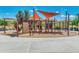 Modern playground featuring a climbing wall, slides, and overhead climbing equipment at 27315 N 83Rd Dr, Peoria, AZ 85383