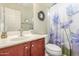 Bright bathroom featuring a single sink vanity and a shower with a decorative floral curtain at 28071 N Superior Rd, San Tan Valley, AZ 85143