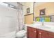 Well-lit bathroom featuring a single sink vanity, tub, and shower with a colorful floral curtain at 28071 N Superior Rd, San Tan Valley, AZ 85143