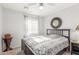 Cozy bedroom featuring a bed, ceiling fan, large mirror, and a window with decorative curtains at 28071 N Superior Rd, San Tan Valley, AZ 85143