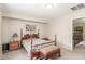 Bedroom with vintage-style bed, neutral walls, and an ensuite bathroom view at 28071 N Superior Rd, San Tan Valley, AZ 85143