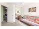Simple bedroom featuring a futon couch, mirror, door, and natural light at 28071 N Superior Rd, San Tan Valley, AZ 85143