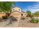 Inviting two-story house with desert landscaping, a front-facing two-car garage and a red front door at 28071 N Superior Rd, San Tan Valley, AZ 85143