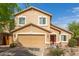 Charming two-story house with desert landscaping, a front-facing two-car garage and a red front door at 28071 N Superior Rd, San Tan Valley, AZ 85143