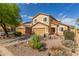 Inviting two-story house with desert landscaping, a front-facing two-car garage and a red front door at 28071 N Superior Rd, San Tan Valley, AZ 85143