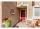 Close up of front door with seasonal flowers, decorative accents and fresh outdoor paint at 28071 N Superior Rd, San Tan Valley, AZ 85143