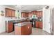 Traditional kitchen with granite countertops, wood cabinets, an island, and modern appliances at 28071 N Superior Rd, San Tan Valley, AZ 85143