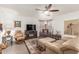Cozy living room with neutral paint, leather seating, and large windows at 28071 N Superior Rd, San Tan Valley, AZ 85143