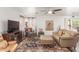 Cozy living room with a ceiling fan, leather seating, and large windows at 28071 N Superior Rd, San Tan Valley, AZ 85143