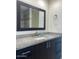 Bathroom featuring granite countertops, modern cabinetry, and a framed mirror at 3022 N 32Nd St # 40, Phoenix, AZ 85018