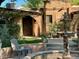 Charming courtyard featuring a beautiful water fountain and comfortable seating area, surrounded by lush greenery at 3022 N 32Nd St # 40, Phoenix, AZ 85018