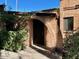 Inviting brick entryway showcasing an arched doorway and lush landscaping, exuding curb appeal at 3022 N 32Nd St # 40, Phoenix, AZ 85018