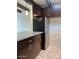 The kitchen features dark cabinets, stainless appliances, an island, and a brick accent wall at 3022 N 32Nd St # 40, Phoenix, AZ 85018