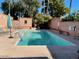 Community pool with sun loungers surrounded by brick walls at 3022 N 32Nd St # 40, Phoenix, AZ 85018