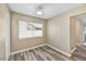 Bright bedroom features neutral walls, new carpet, baseboards, and a large window for natural light at 3154 E Clarendon Ave, Phoenix, AZ 85016
