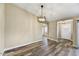 The dining room features updated flooring, a modern light fixture, and access to the entryway and other rooms at 3154 E Clarendon Ave, Phoenix, AZ 85016
