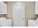 The laundry room provides white cabinets, a laundry sink, and a washer and dryer at 3154 E Clarendon Ave, Phoenix, AZ 85016