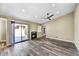 Inviting living room with a fireplace, wood-look floors, a ceiling fan, and sliding glass doors to the patio at 3154 E Clarendon Ave, Phoenix, AZ 85016