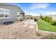 Relaxing backyard with a stone patio, string lights, and a grassy area perfect for entertaining at 32341 N Union St, San Tan Valley, AZ 85143
