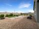 Backyard features a gravel patio, planters and privacy wall at 32341 N Union St, San Tan Valley, AZ 85143