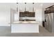 Open kitchen featuring a large island, stainless steel appliances, and dark wood cabinetry at 32341 N Union St, San Tan Valley, AZ 85143