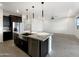 Spacious kitchen features a stainless steel dishwasher and kitchen island at 32341 N Union St, San Tan Valley, AZ 85143