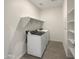 Bright laundry room features washer, dryer, shelves and laminate flooring at 32341 N Union St, San Tan Valley, AZ 85143