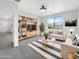 Bright living room with stylish furniture, a large window, and a decorative entertainment center at 32341 N Union St, San Tan Valley, AZ 85143