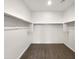 Spacious walk-in closet features neutral carpeting and metal clothes rails at 32341 N Union St, San Tan Valley, AZ 85143