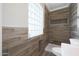 Modern bathroom featuring stylish wood-look tile and shower with glass block window at 3245 N 43Rd N Ave, Phoenix, AZ 85031